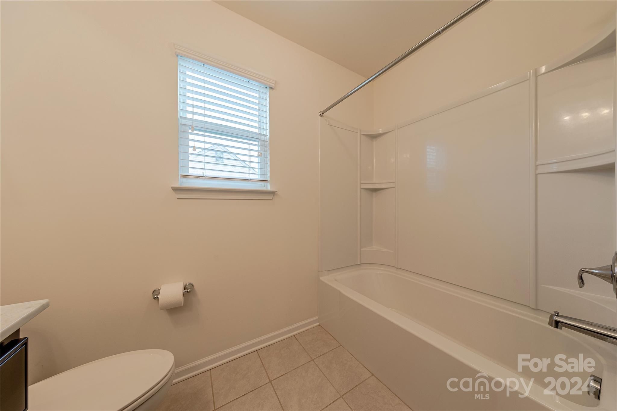 9604 Steele Meadow Road Charlotte, NC 28273 - Photo 35 of 46 a white bath tub sitting next to a white toilet