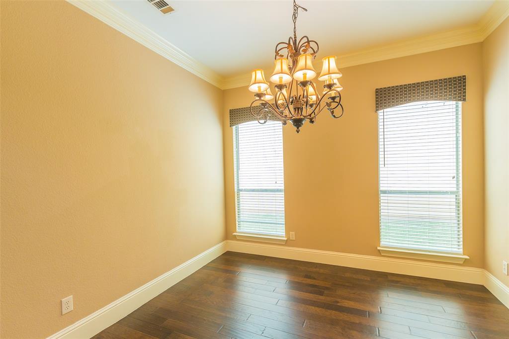 7804 Keechie Drive McKinney, TX 75070 - Photo 12 of 39 a view of a room with wooden floor chandelier and a window