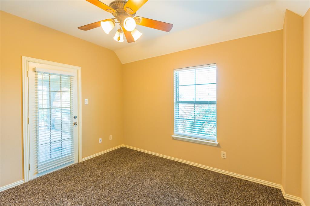 7804 Keechie Drive McKinney, TX 75070 - Photo 29 of 39 an empty room with windows and chandelier fan