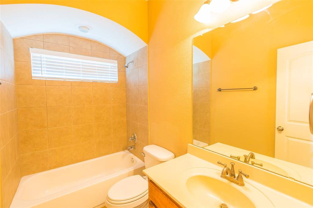 7804 Keechie Drive McKinney, TX 75070 - Photo 30 of 39 a bathroom with a sink mirror vanity and toilet