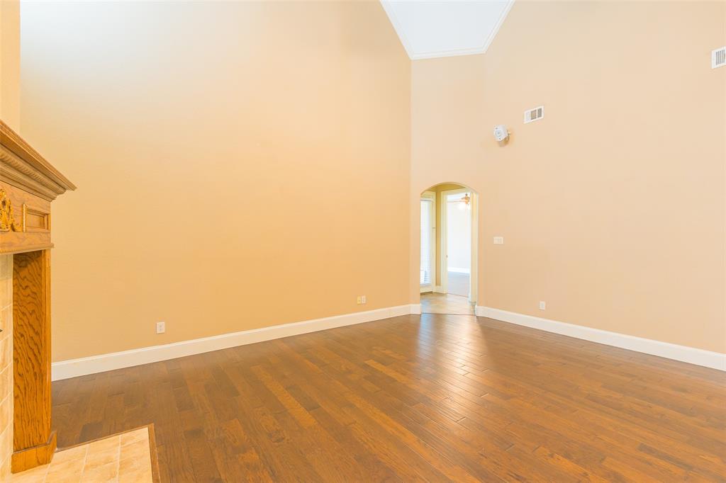 7804 Keechie Drive McKinney, TX 75070 - Photo 7 of 39 a view of an empty room with wooden floor and a window