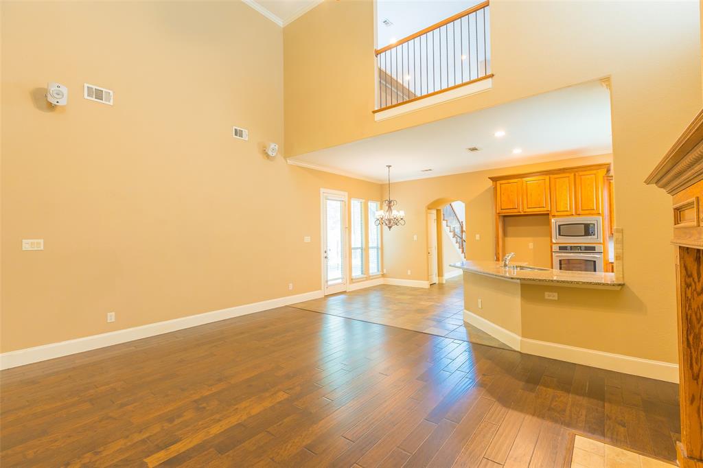 7804 Keechie Drive McKinney, TX 75070 - Photo 9 of 39 a view of an empty room with wooden floor and a window
