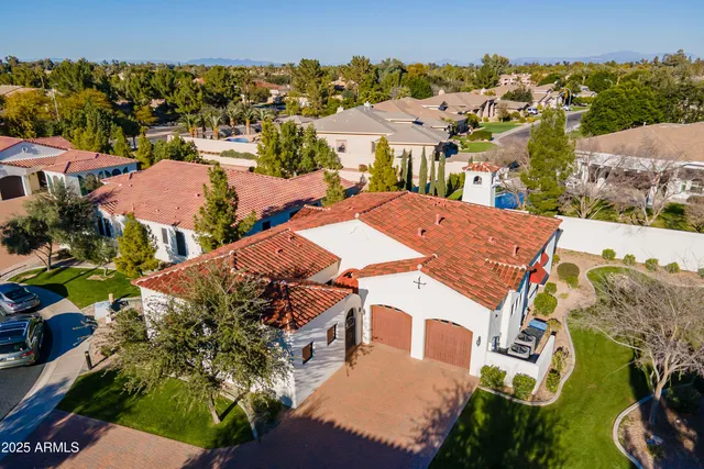 an aerial view of a house with a yard basket ball court and outdoor seating