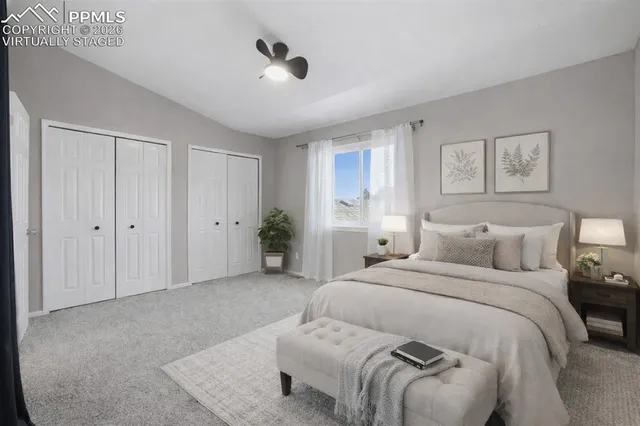 a spacious bedroom with a bed and a chandelier