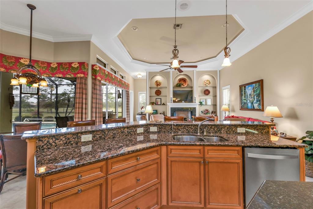 5021 Sable Key Circle Punta Gorda, FL 33955 - Photo 25 of 77 a kitchen with stainless steel appliances granite countertop a sink a counter space and a view of living room