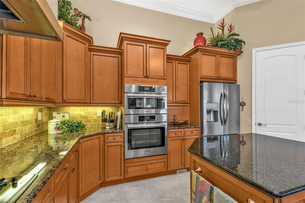 5021 Sable Key Circle Punta Gorda, FL 33955 - Photo 28 of 77 a kitchen with stainless steel appliances granite countertop a refrigerator a stove and a sink with wooden floor