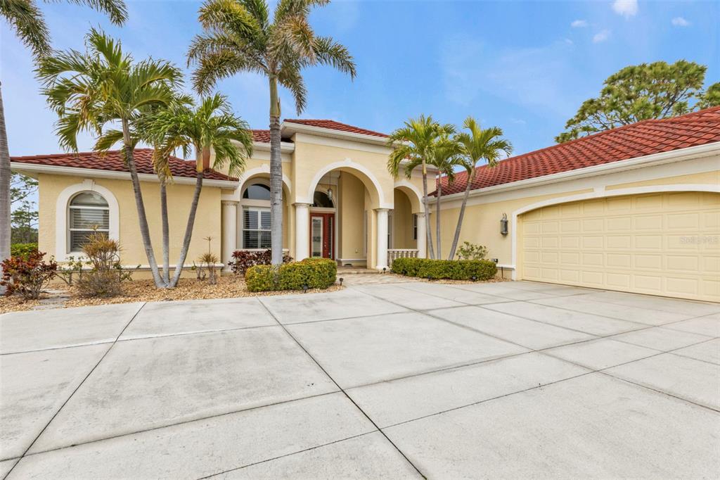 5021 Sable Key Circle Punta Gorda, FL 33955 - Photo 3 of 77 a front view of a house with garden
