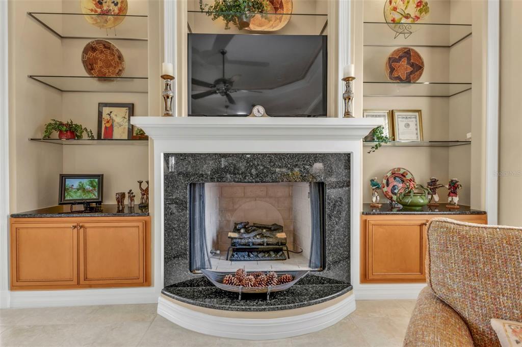 5021 Sable Key Circle Punta Gorda, FL 33955 - Photo 35 of 77 a living room with a fireplace and a wooden floor