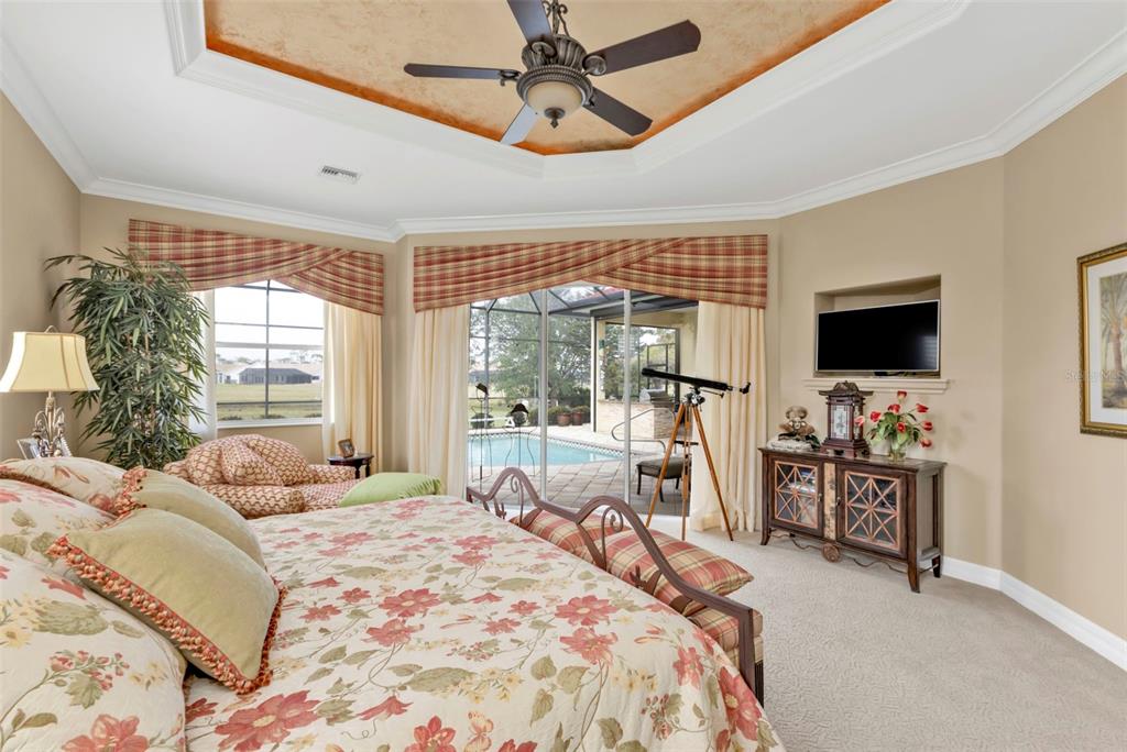 5021 Sable Key Circle Punta Gorda, FL 33955 - Photo 38 of 77 a bedroom with a large bed and a flat screen tv