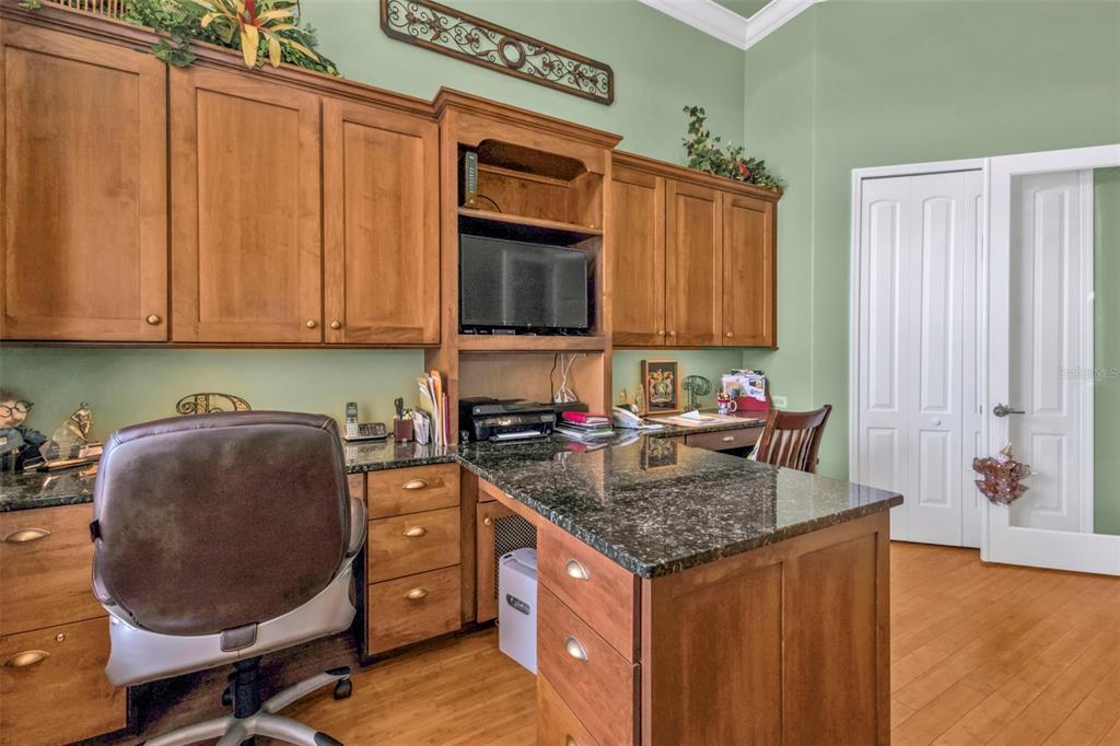 5021 Sable Key Circle Punta Gorda, FL 33955 - Photo 47 of 77 a kitchen with stainless steel appliances granite countertop a sink dishwasher stove and cabinets with wooden floor