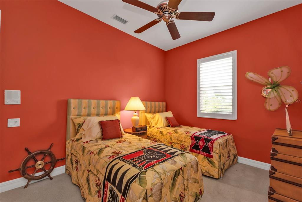 5021 Sable Key Circle Punta Gorda, FL 33955 - Photo 54 of 77 a bedroom with a bed and a chandelier