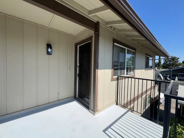 a view of a porch with wooden floor and stairs