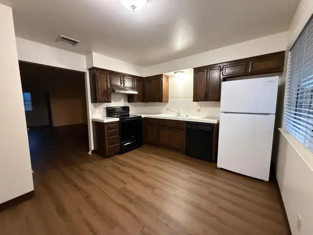 a kitchen with stainless steel appliances a refrigerator and a stove top oven