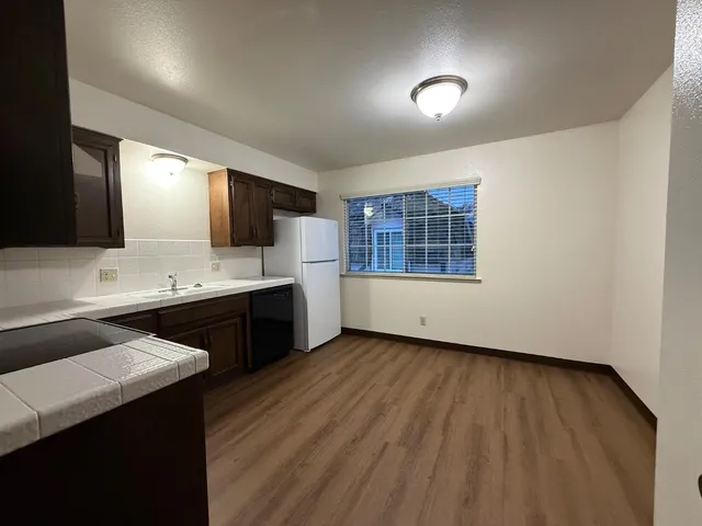 a kitchen with a sink cabinets and wooden floor