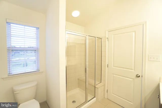 a bathroom with a shower and toilet