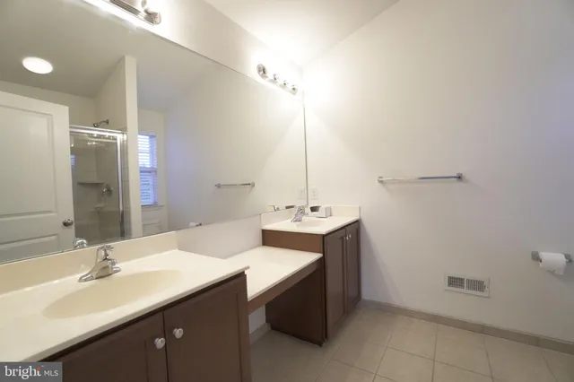 a bathroom with a sink double vanity and a mirror