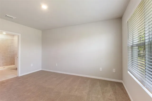 a view of an empty room and a window