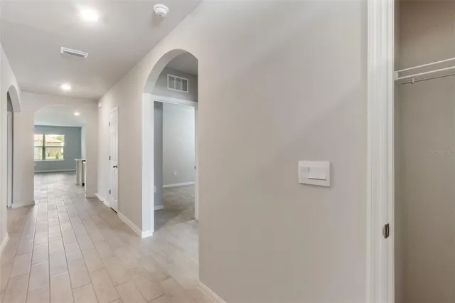 a view of a hallway with wooden floor