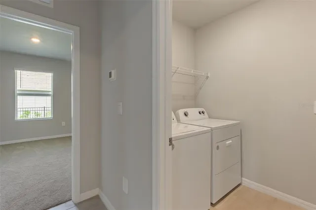 a utility room with cabinets washer and dryer