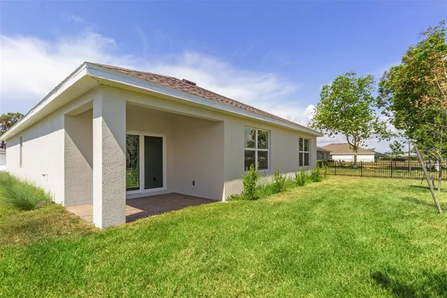 a view of a house with a backyard porch and a garden