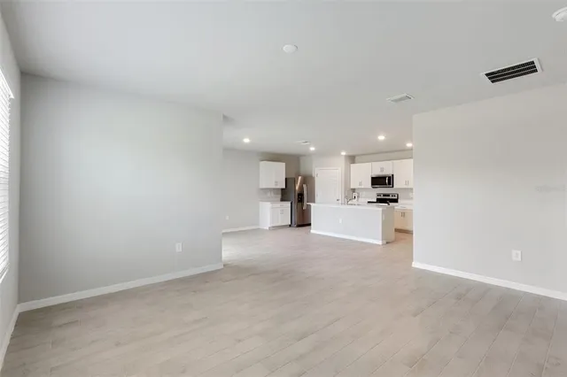 a view of a kitchen with a sink and cabinets