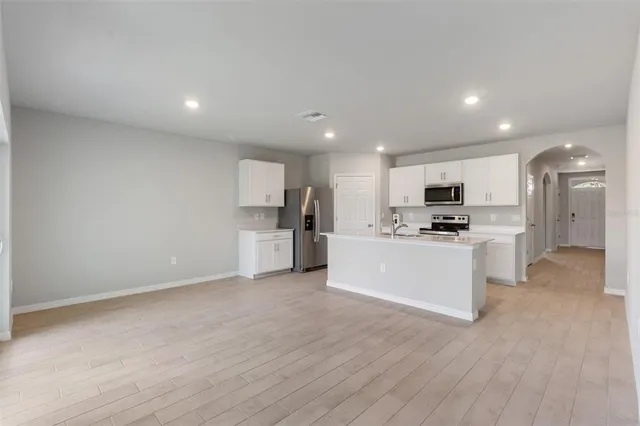 a kitchen with white cabinets and white appliances