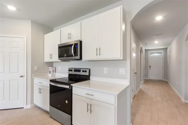 a view of a kitchen with electric appliances