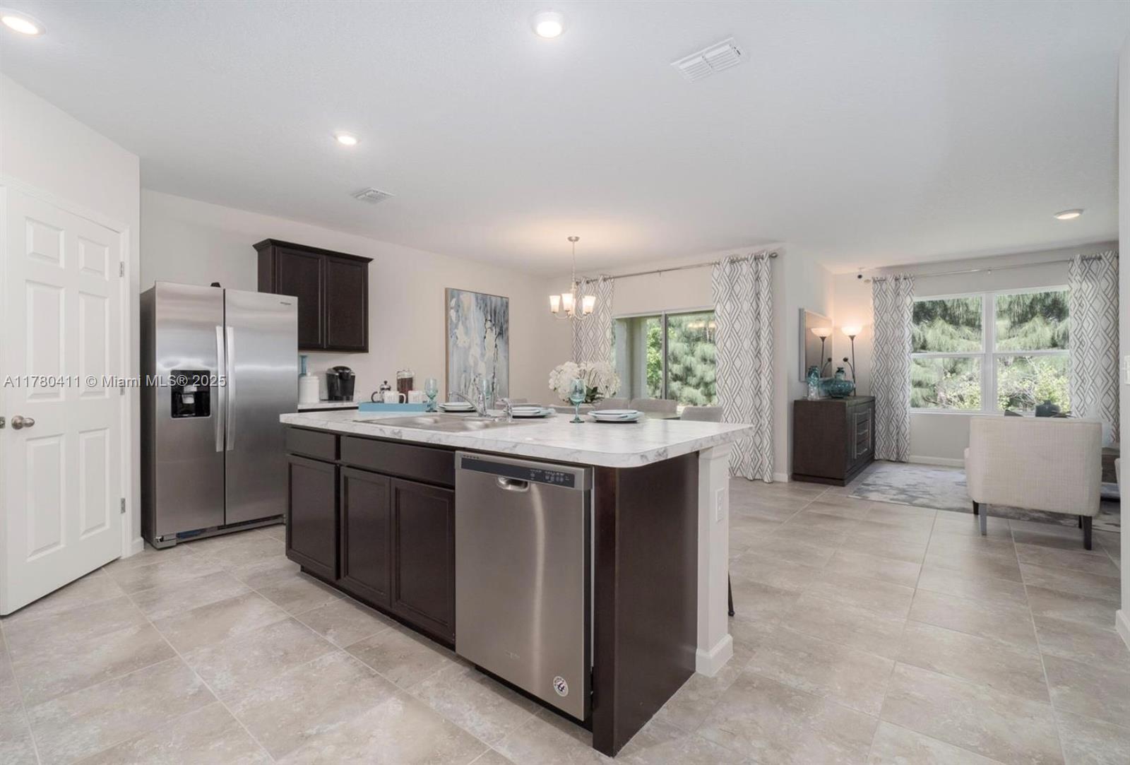 3743 Southwest Port St Lucie Boulevard Port St. Lucie, FL 34953 - Photo 11 of 22 a kitchen with refrigerator cabinets and furniture