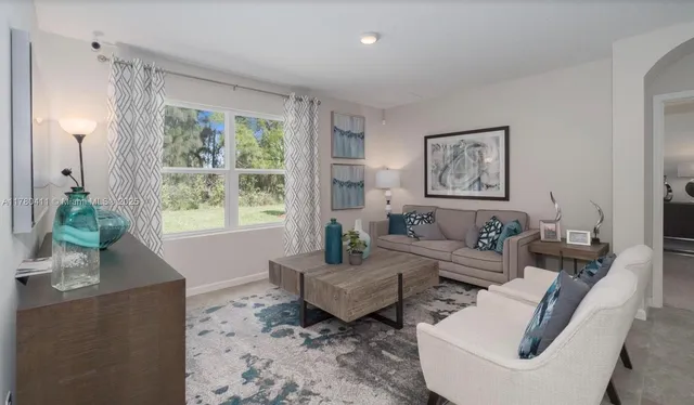 a living room with stainless steel appliances kitchen island granite countertop a view of kitchen dining table and chairs