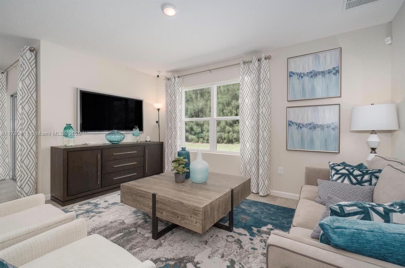 3743 Southwest Port St Lucie Boulevard Port St. Lucie, FL 34953 - Photo 14 of 22 a living room with furniture and a flat screen tv