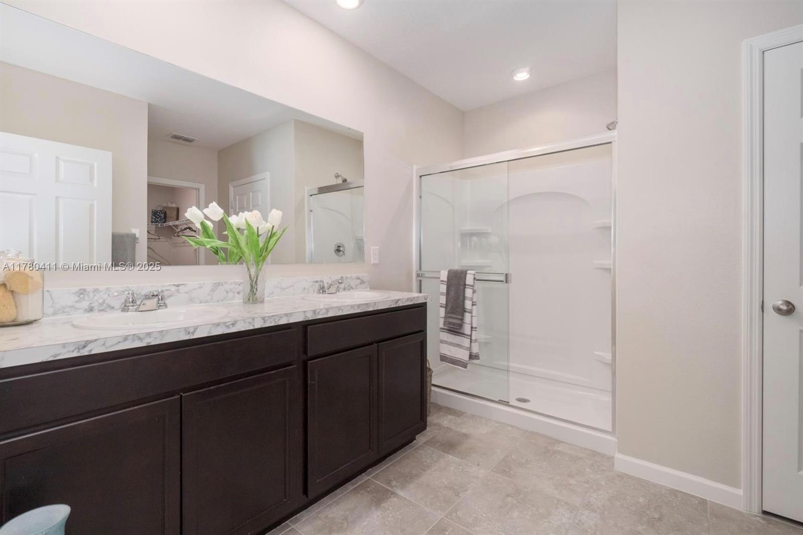 3743 Southwest Port St Lucie Boulevard Port St. Lucie, FL 34953 - Photo 18 of 22 a bathroom with a granite countertop sink and a mirror
