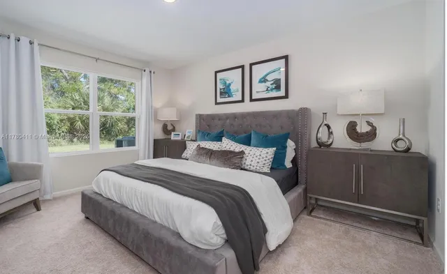 a bed room with a bed and a chair