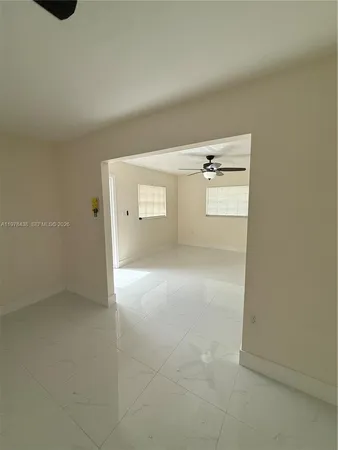a view of kitchen with refrigerator stove and cabinets