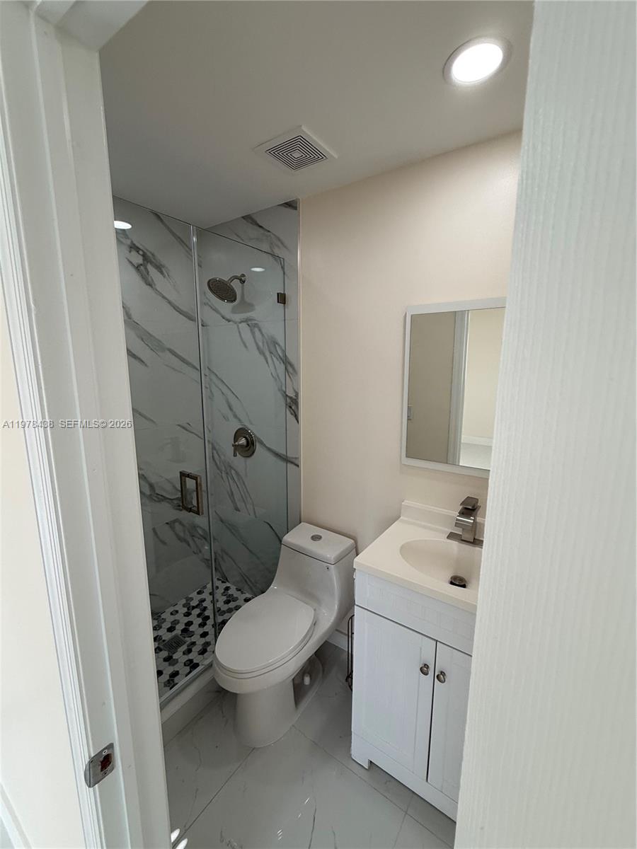 11690 Southwest 185th Street, Unit 1 Miami, FL 33157 - Photo 8 of 11 a bathroom with a toilet sink and shower