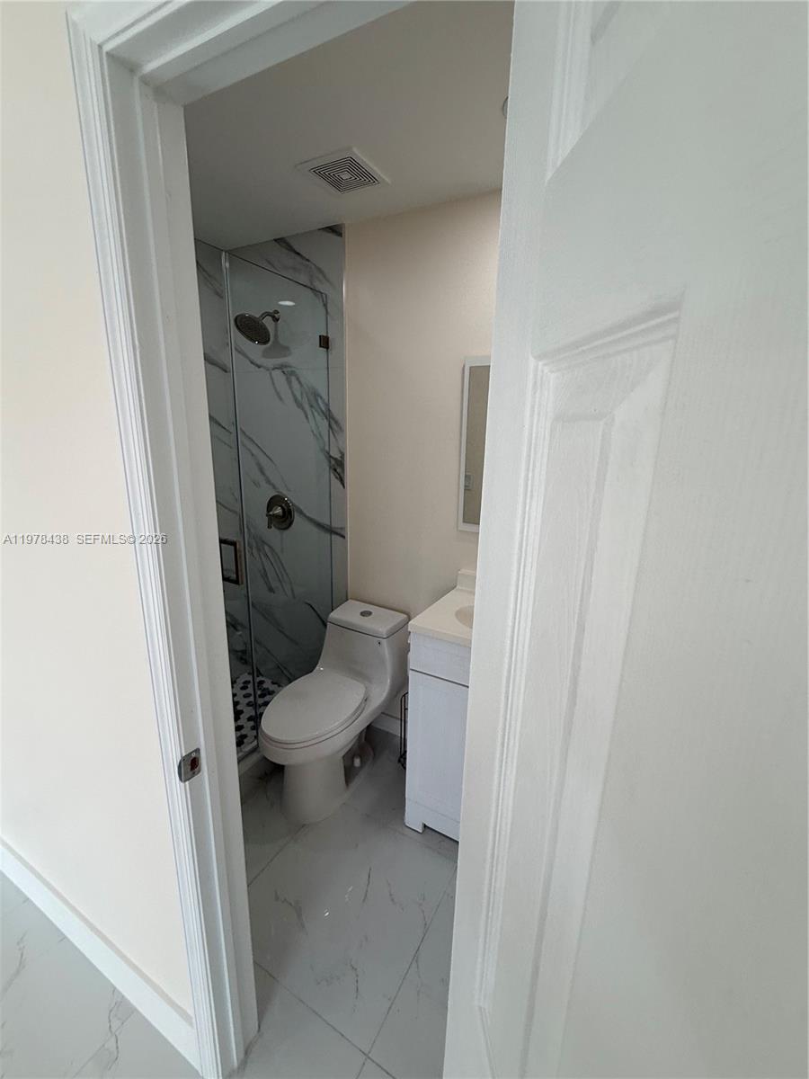 11690 Southwest 185th Street, Unit 1 Miami, FL 33157 - Photo 9 of 11 a bathroom with a toilet and a shower