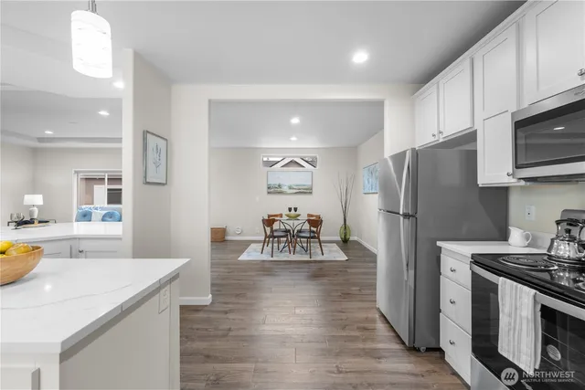 a kitchen with a refrigerator a stove top oven a sink and dishwasher