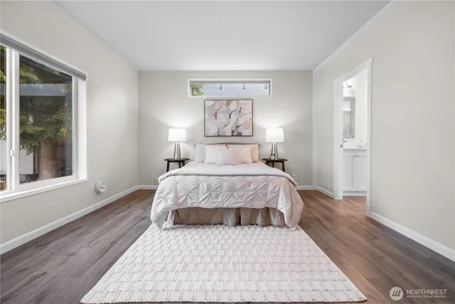 a bedroom with a large bed and a window