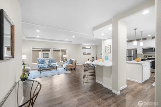 a view of living room kitchen with furniture and wooden floor