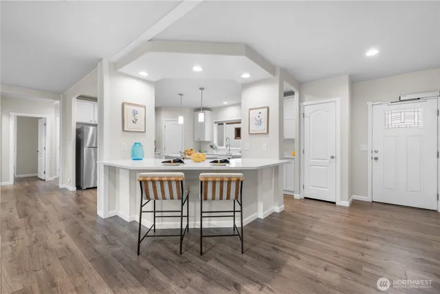 a dining room with furniture and wooden floor