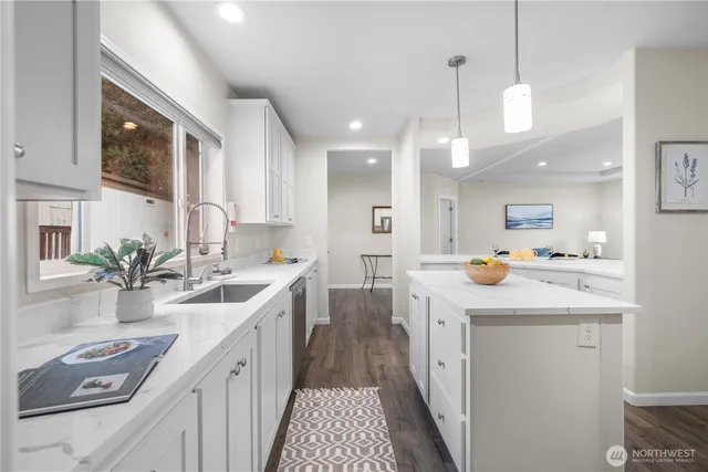 a kitchen with a sink stove and cabinets