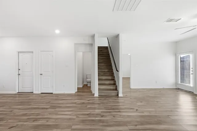 a view of entryway with wooden floor and stairs