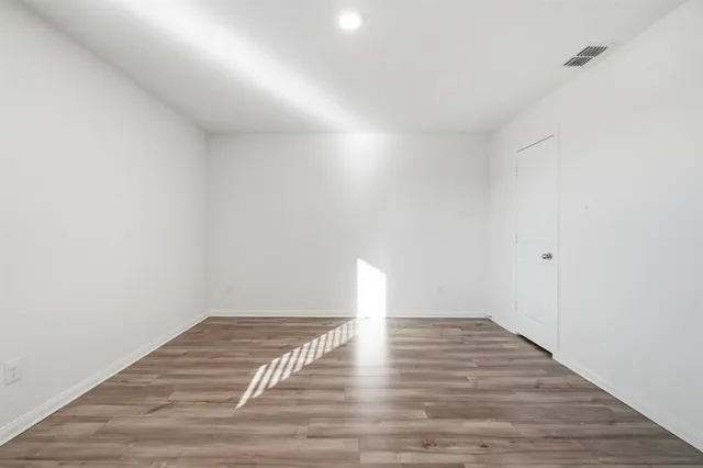 a view of a room with wooden floor