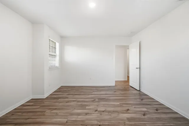 a view of room with wooden floor