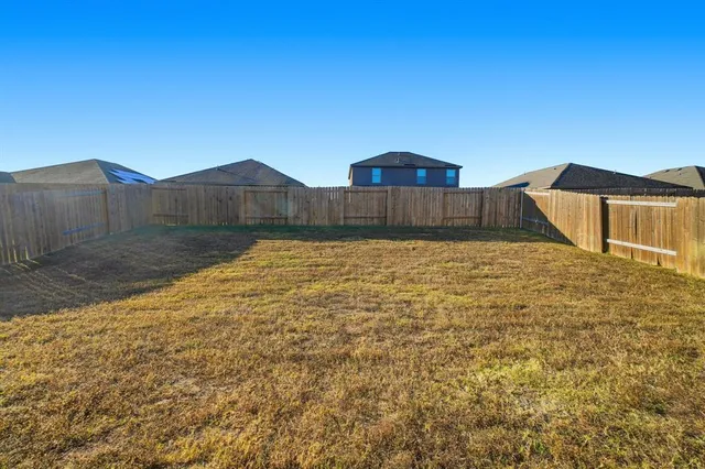 a view of a back yard of the house