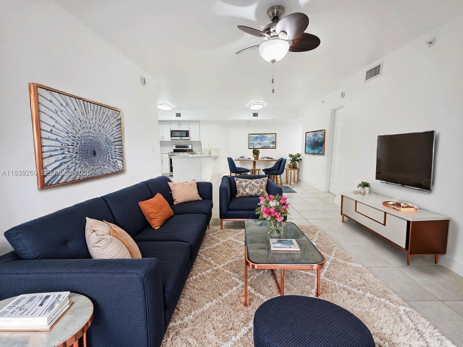 2620 South University Drive, Unit 111 Davie, FL 33328 - Photo 11 of 49 a living room with furniture and a flat screen tv