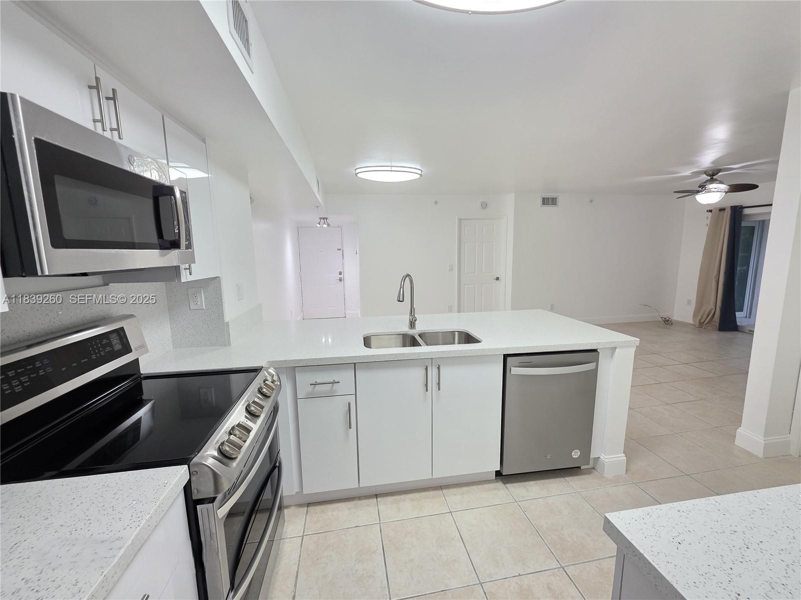 2620 South University Drive, Unit 111 Davie, FL 33328 - Photo 16 of 49 a kitchen with a sink stove and microwave