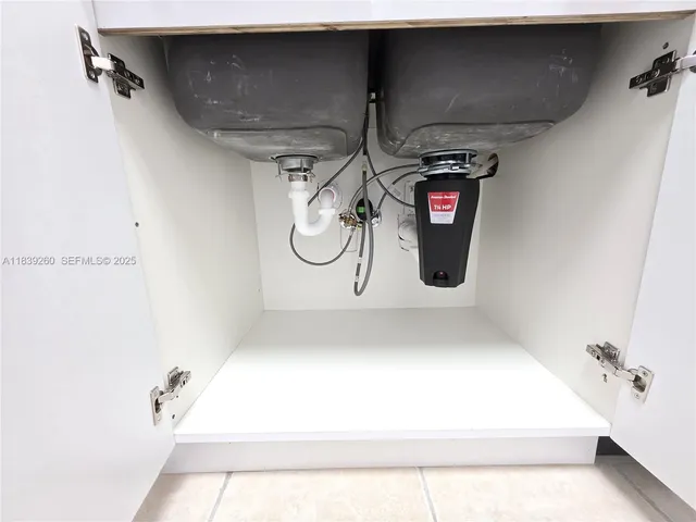 an empty room with a window and a ceiling fan