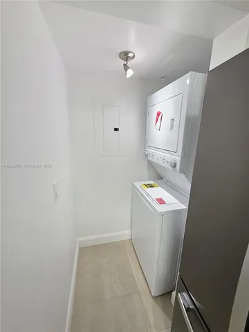 an empty room with a fan & a ceiling fan