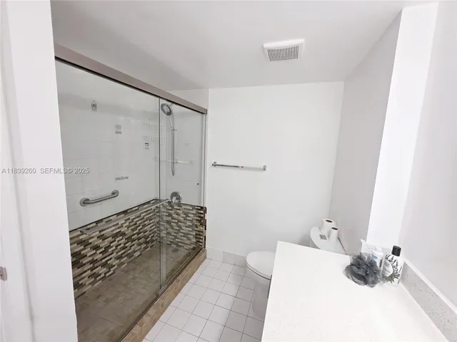 a living room with furniture a large window and a wooden floor