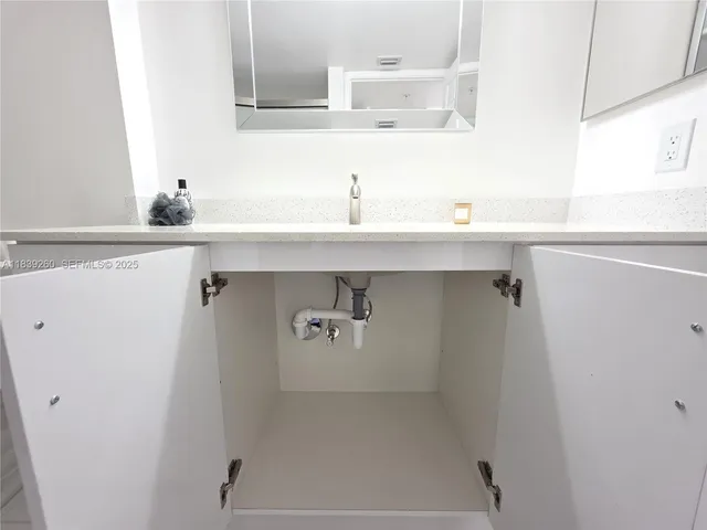 a dining room with wooden floor a glass table and chairs